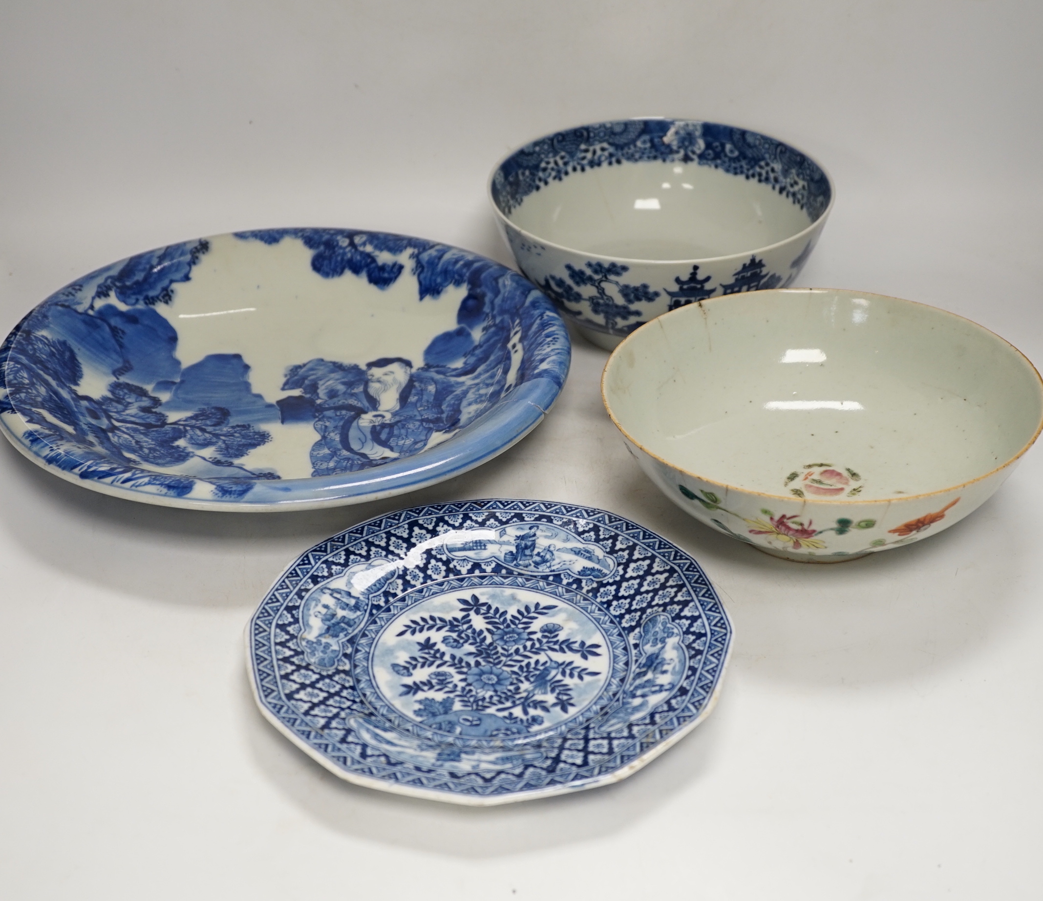 Assorted Chinese and Japanese ceramics comprising a famille rose bowl, two blue and white plates and a blue and white bowl, largest 30cm in diameter